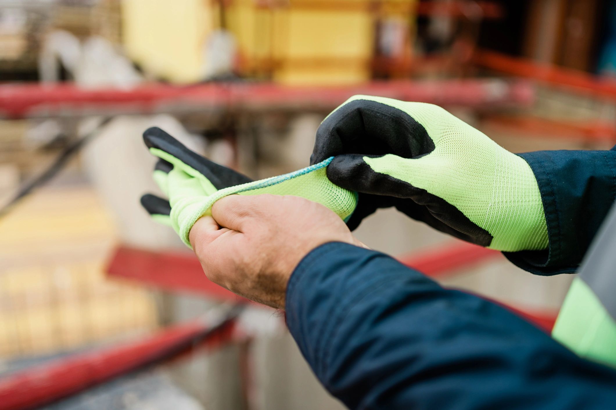 Construction worker putting on protective work gloves