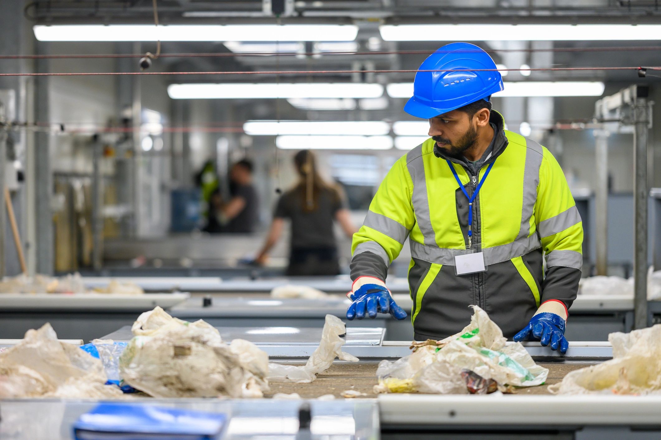 Worker in safety gear at an industrial facility
